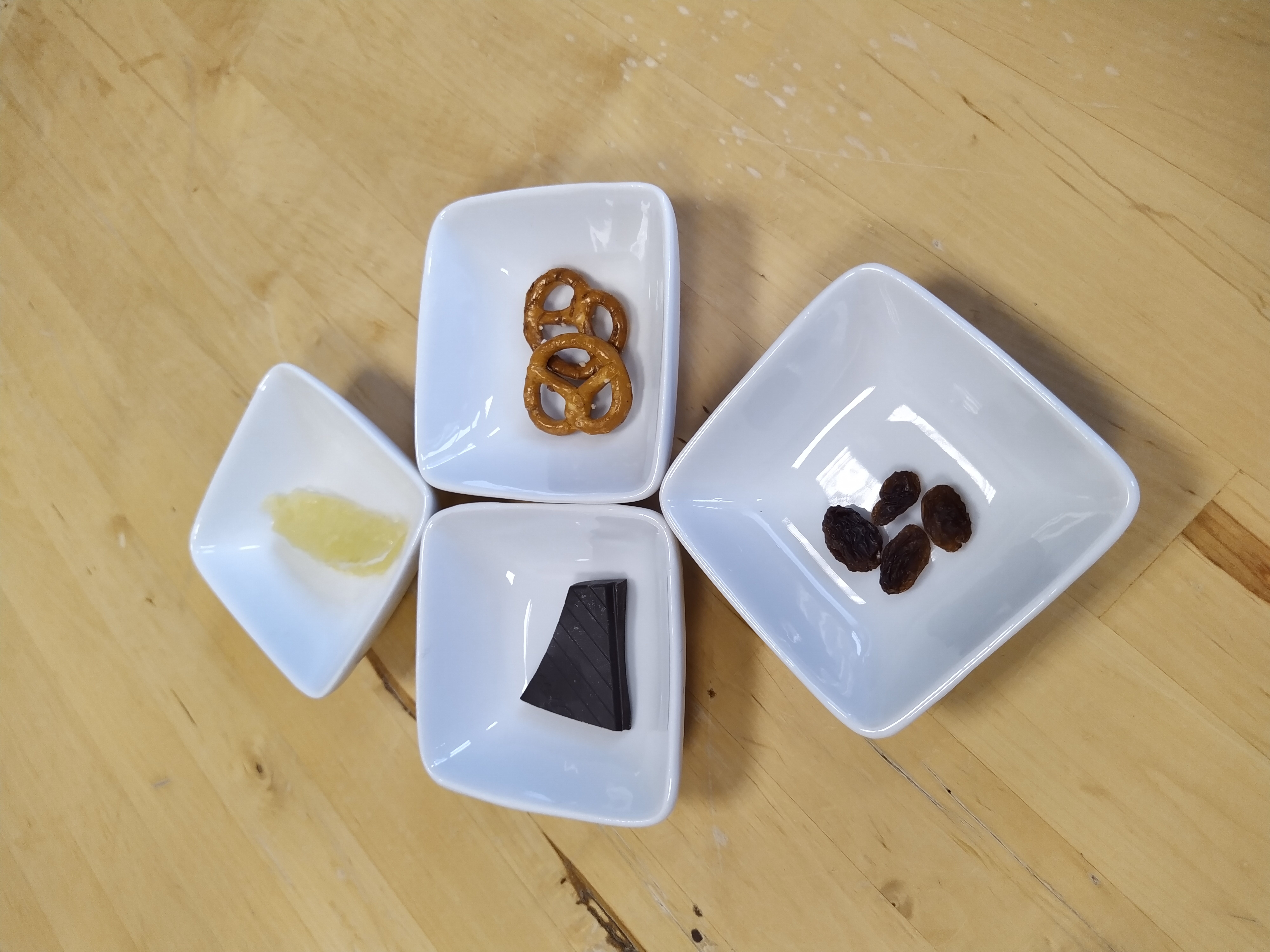 Table 1 – Le goût
Sur la table, disposer la fiche consigne « le sens du Goût » ainsi que les 4 aliments choisis : un à la saveur acide, un à la saveur sucrée, un à la saveur salée et un à la saveur amer.
 
Exemple
Assiette 1—saveur acide : bonbons acidulés
Assiette 2—saveur sucrée: sucre candy
Assiette 3—saveur amer : chocolat noir à 85 % de cacao
Assiette 4—saveur salé : pipas
 
Astuce : découper les aliments en petits morceaux et les rendre disponibles en quantité suffisante afin que tous les participants puissent y goûter.
